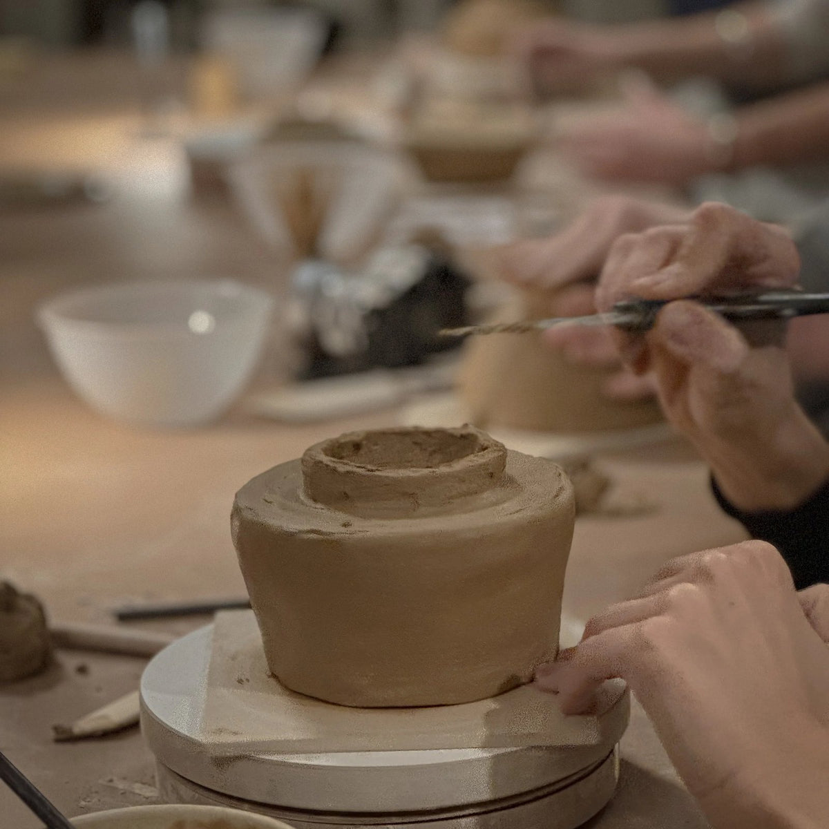Guests shaping clay